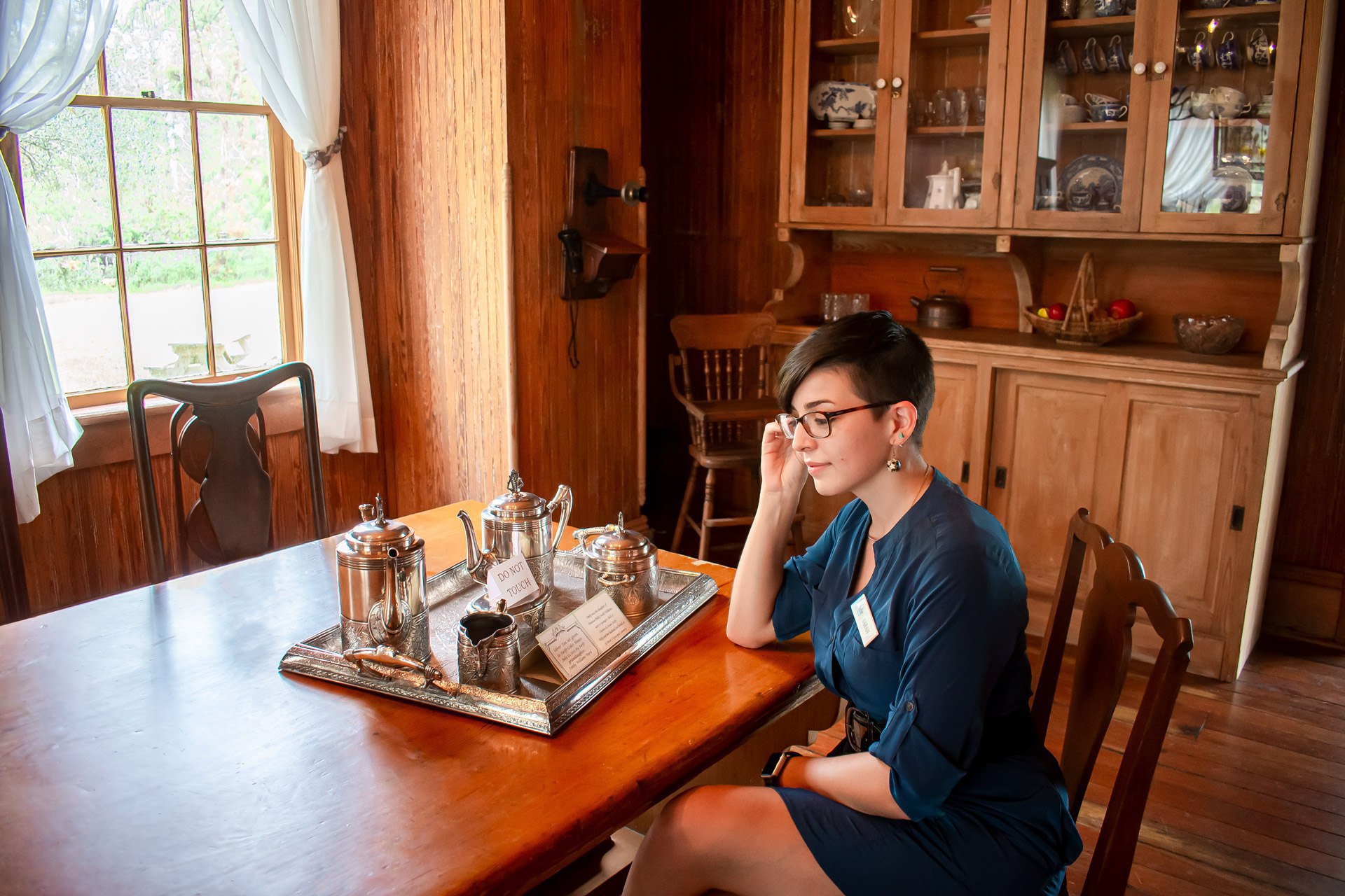 Sarah sitting with a silver Tea Tray