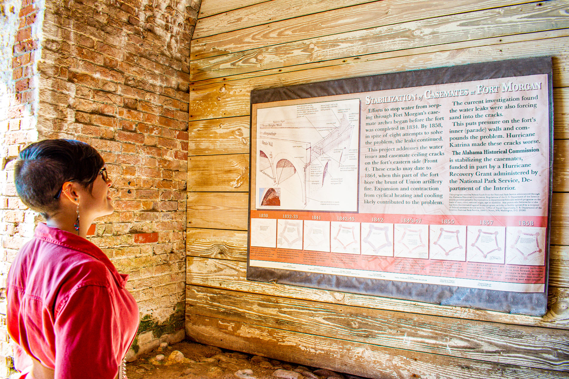 Sarah looking at informational plaque in Fort Morgan