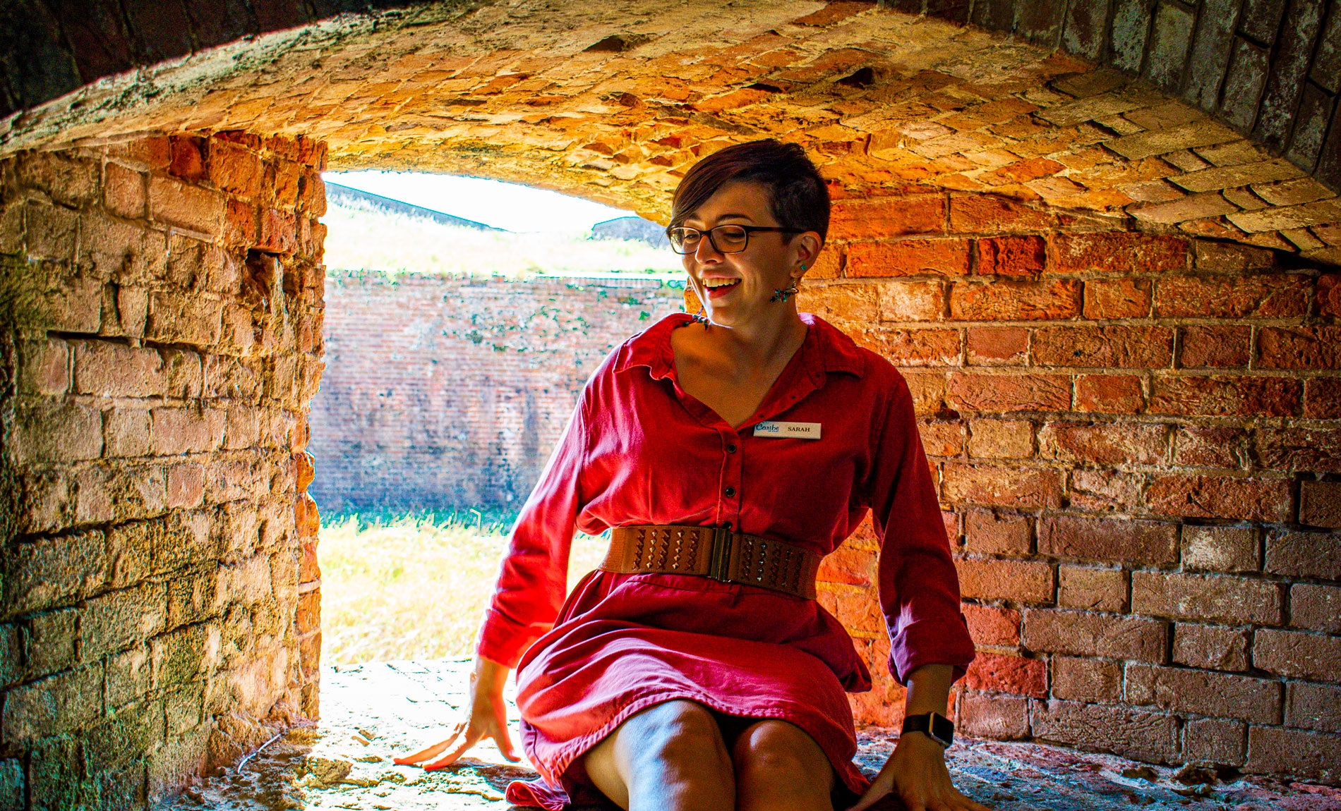 Sarah sitting in a brick opening that held canons