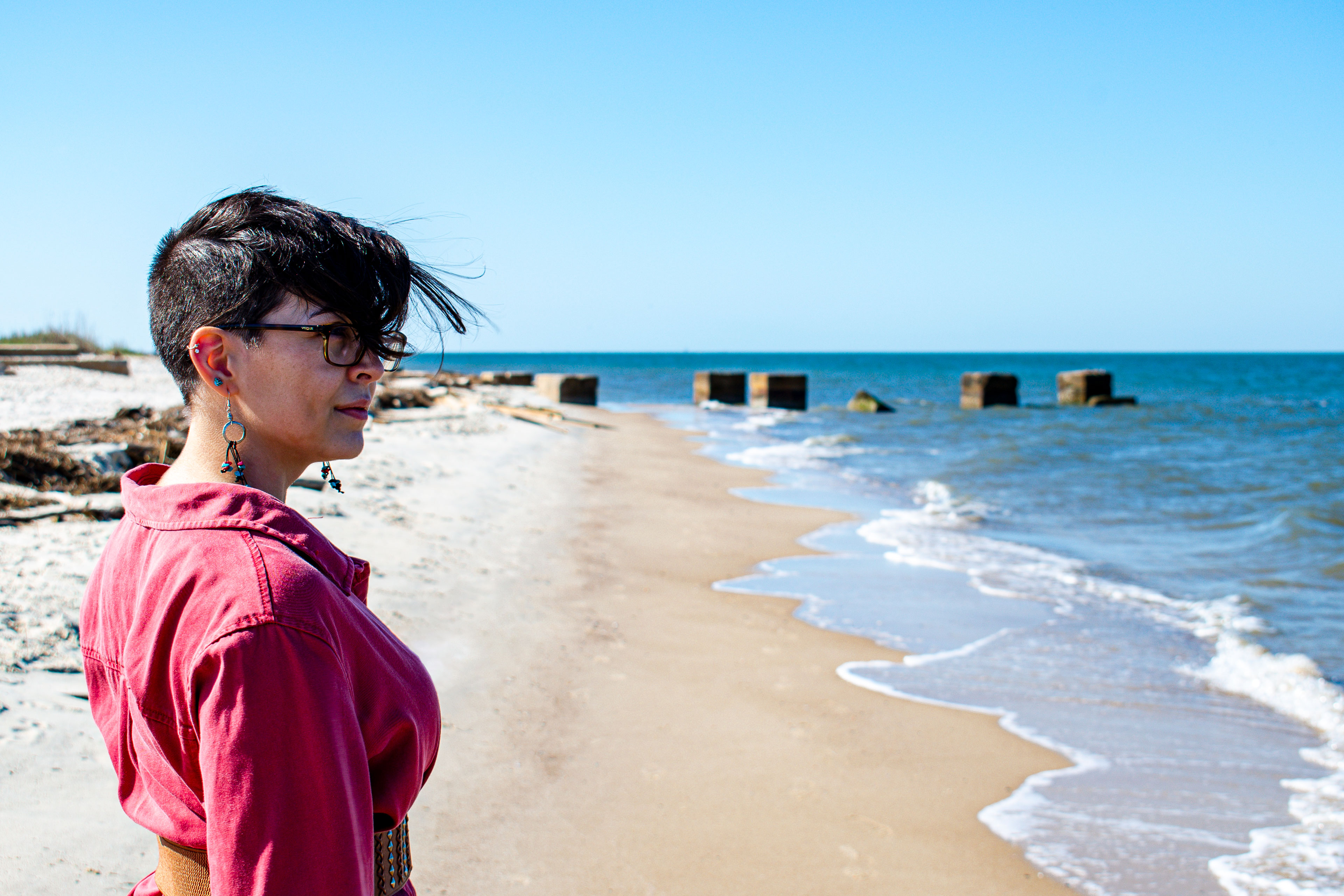 Sarah over looking a broken pier at Fort Morgan