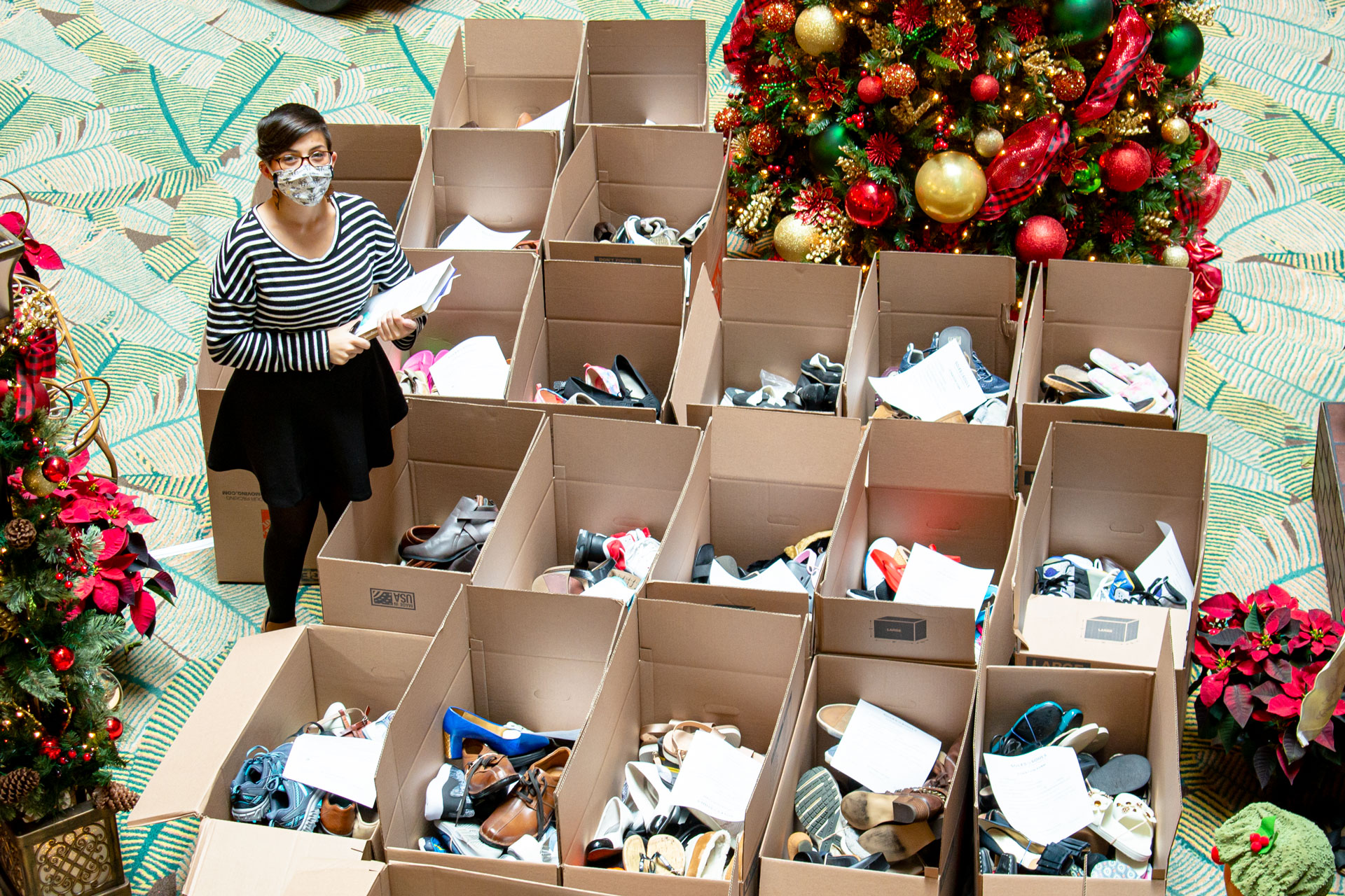 Sarah with many boxes of shoes