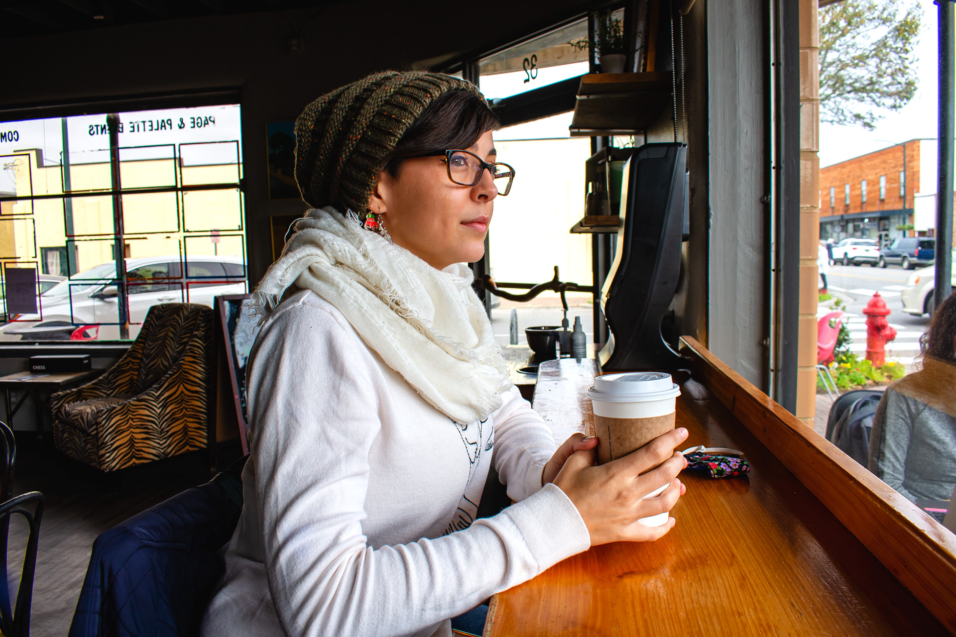 Sarah looking out the window of Latte Da